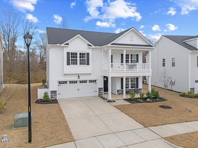 view of front of home with driveway, covered porch, a garage, and board and batten siding