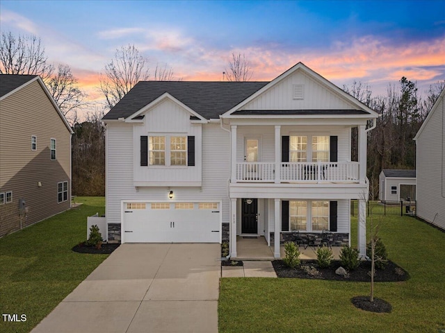 view of front facade featuring a garage, concrete driveway, a porch, board and batten siding, and a front yard