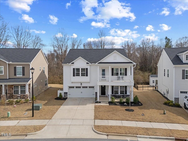 view of front of house featuring driveway, a balcony, an attached garage, covered porch, and board and batten siding