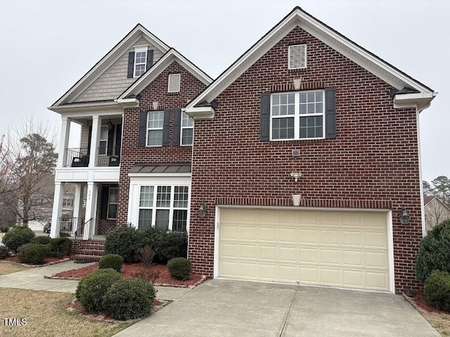 traditional-style home with brick siding, a standing seam roof, concrete driveway, and a garage