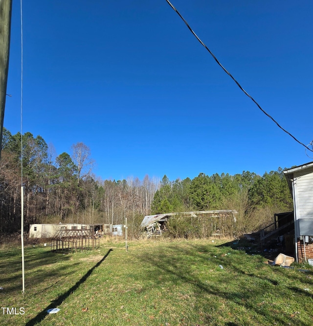 view of yard with a wooded view