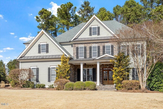 view of front facade featuring a standing seam roof, a shingled roof, metal roof, and french doors