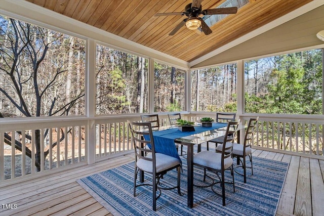 wooden terrace with ceiling fan and outdoor dining area