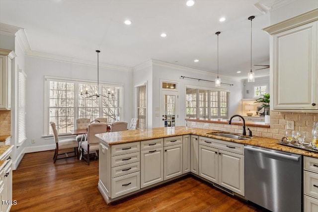 kitchen with tasteful backsplash, dishwasher, dark wood-style floors, crown molding, and a sink