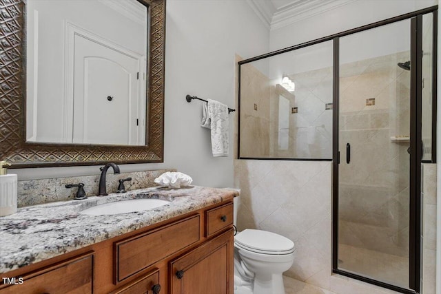 bathroom featuring a stall shower, crown molding, and vanity