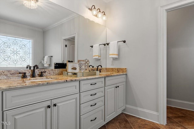 full bathroom with crown molding, a sink, baseboards, and double vanity