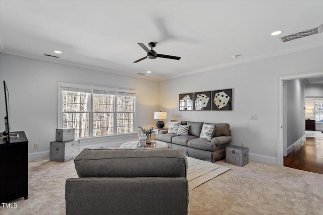 living area featuring carpet, visible vents, and crown molding