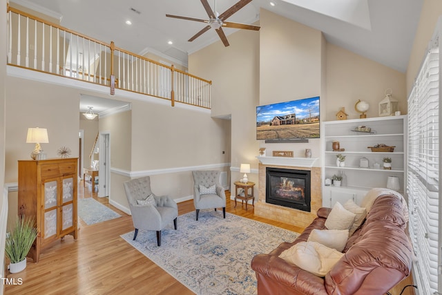 living room featuring high vaulted ceiling, wood finished floors, visible vents, baseboards, and a multi sided fireplace