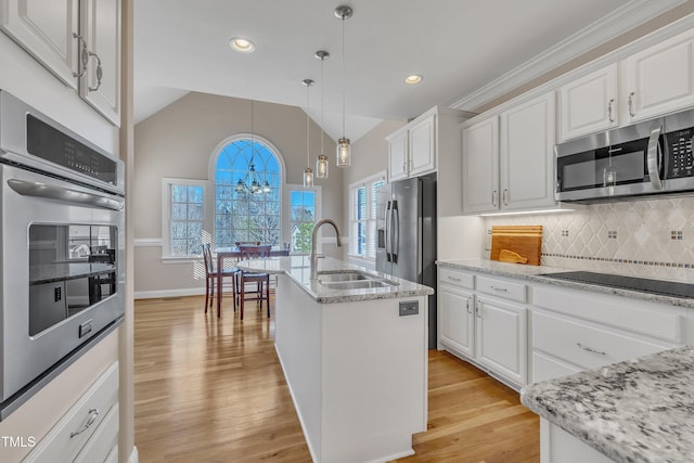 kitchen with light wood-style floors, white cabinetry, appliances with stainless steel finishes, and a sink