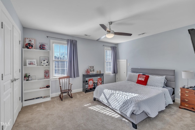 bedroom featuring a ceiling fan, baseboards, visible vents, and carpet flooring