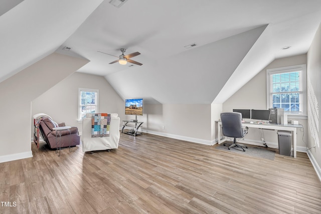 office with visible vents, lofted ceiling, light wood-style flooring, and baseboards