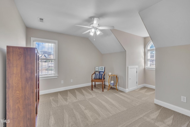 interior space featuring carpet, visible vents, baseboards, and vaulted ceiling