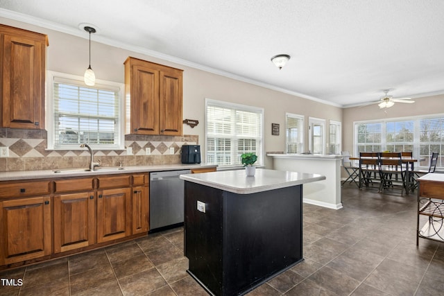 kitchen featuring a kitchen island, a sink, stainless steel dishwasher, backsplash, and brown cabinets