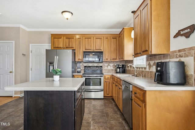 kitchen with a center island, stainless steel appliances, a sink, and light countertops