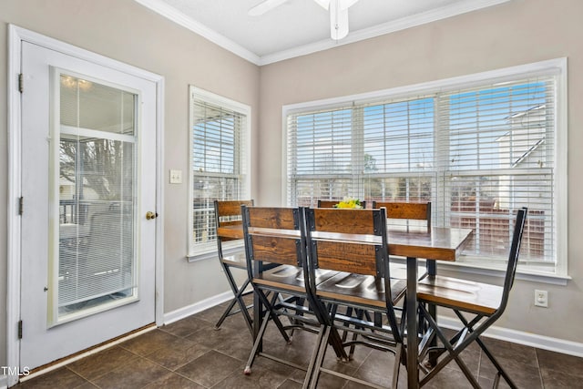 dining space with ceiling fan, baseboards, and crown molding