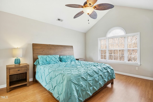 bedroom featuring baseboards, visible vents, ceiling fan, wood finished floors, and vaulted ceiling