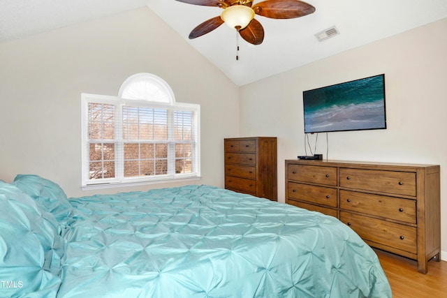 bedroom featuring vaulted ceiling, ceiling fan, visible vents, and light wood-style floors