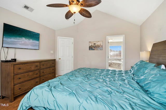 bedroom featuring lofted ceiling, visible vents, a ceiling fan, connected bathroom, and wood finished floors