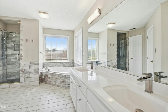 bathroom featuring a garden tub, a sink, and a shower stall