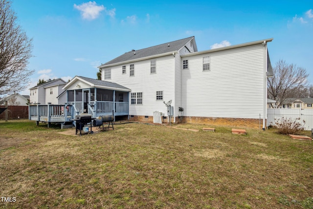 rear view of property featuring a sunroom, crawl space, a yard, and fence