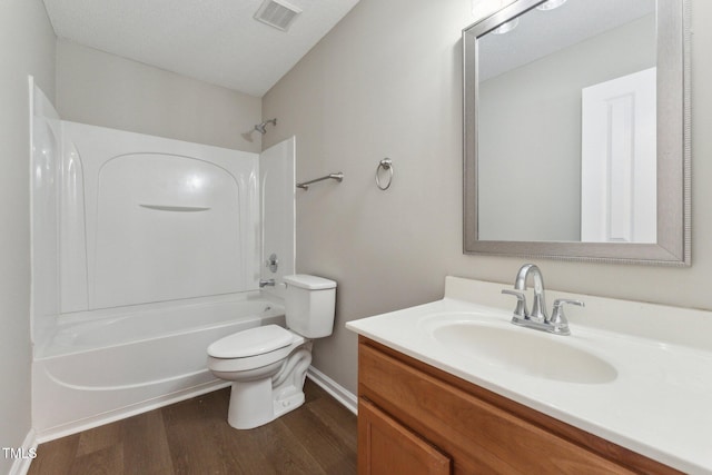 bathroom featuring shower / bath combination, visible vents, toilet, vanity, and wood finished floors