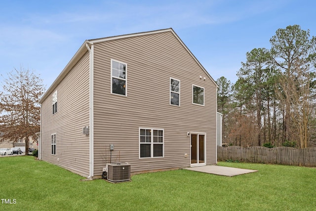 back of property with central AC unit, a patio area, fence, and a lawn