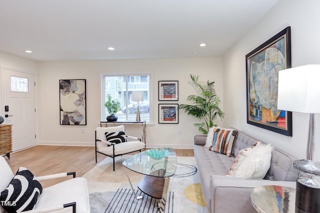 living room featuring baseboards, plenty of natural light, light wood-style flooring, and recessed lighting