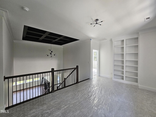 carpeted empty room featuring built in features, coffered ceiling, crown molding, and baseboards