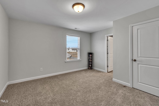 unfurnished bedroom with visible vents, baseboards, and light colored carpet