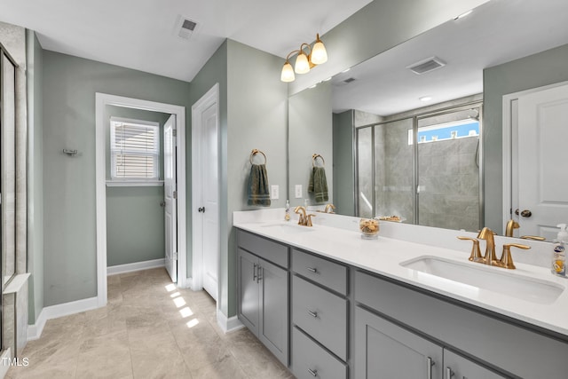 full bathroom with plenty of natural light, a sink, and visible vents