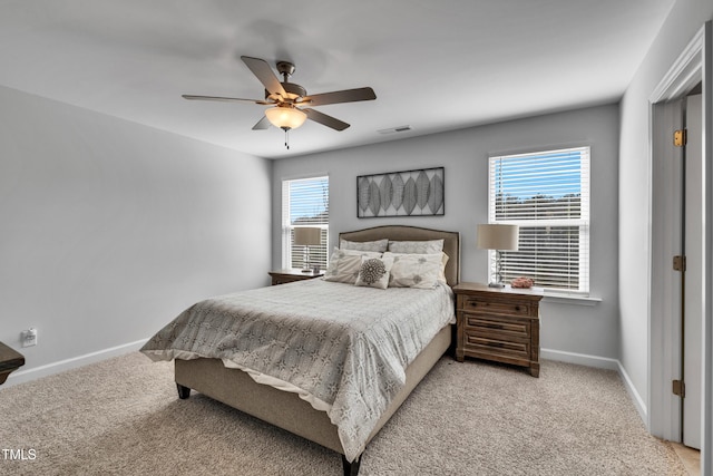 bedroom with multiple windows, visible vents, and baseboards