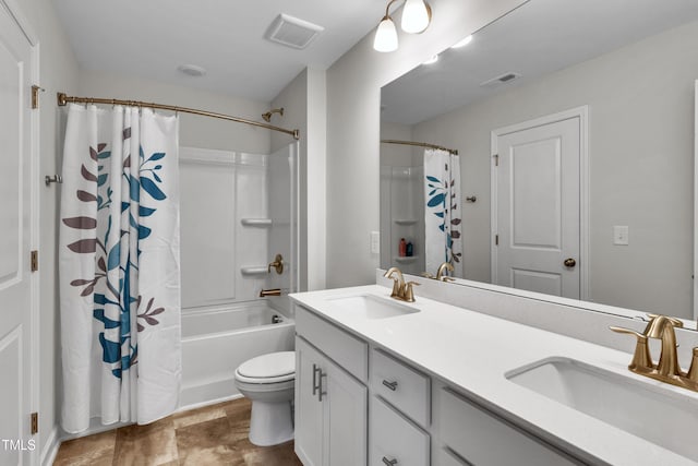 bathroom featuring visible vents, a sink, and double vanity