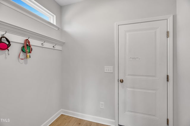 mudroom with light wood finished floors and baseboards