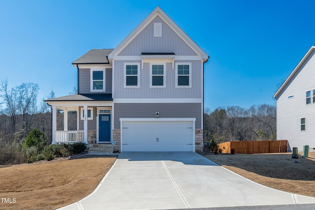 view of front facade with concrete driveway, covered porch, board and batten siding, a garage, and stone siding