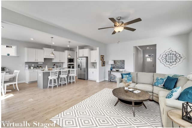 90 Rigsby Ave, Four Oaks, NC 27524 - living room featuring baseboards, ceiling fan, and light wood finished floors