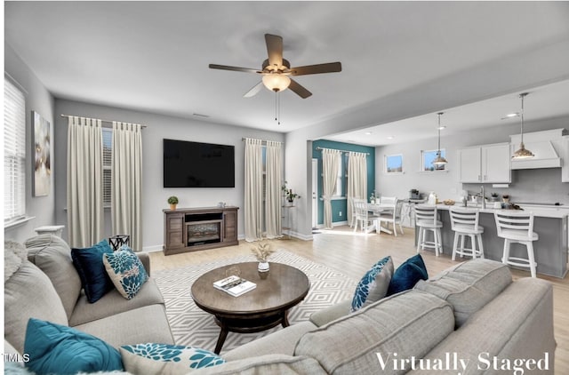 90 Rigsby Ave, Four Oaks, NC 27524 - living room with a healthy amount of sunlight, light wood-type flooring, and ceiling fan