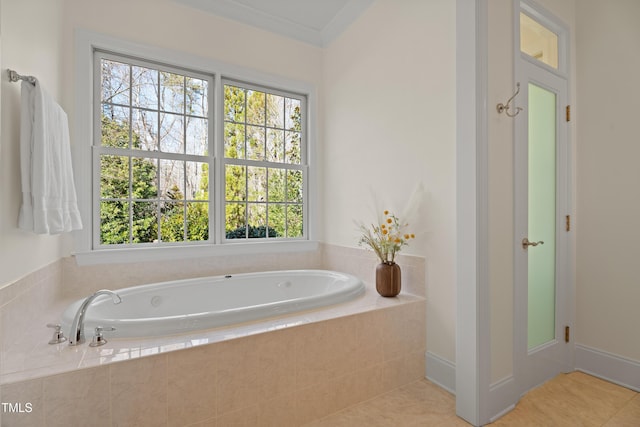 full bath with ornamental molding, a bath, and tile patterned floors