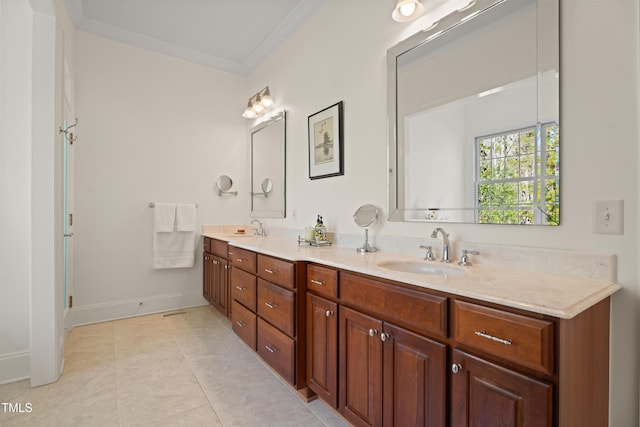 bathroom with ornamental molding, tile patterned floors, a sink, and double vanity