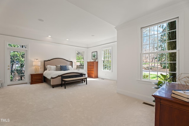 bedroom featuring visible vents, crown molding, light carpet, and baseboards