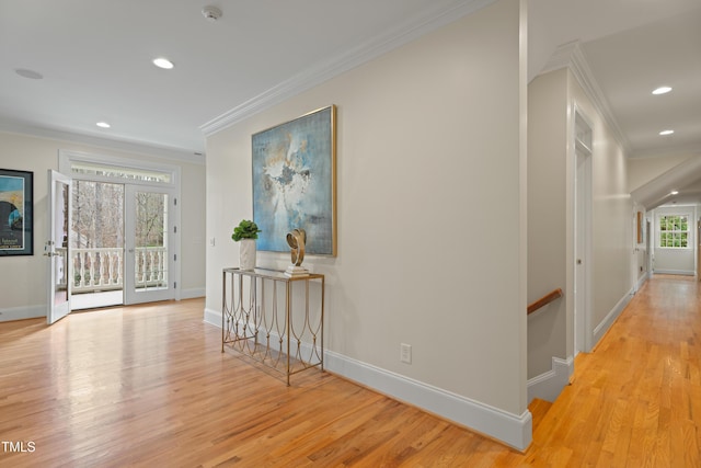 corridor featuring baseboards, ornamental molding, wood finished floors, an upstairs landing, and recessed lighting