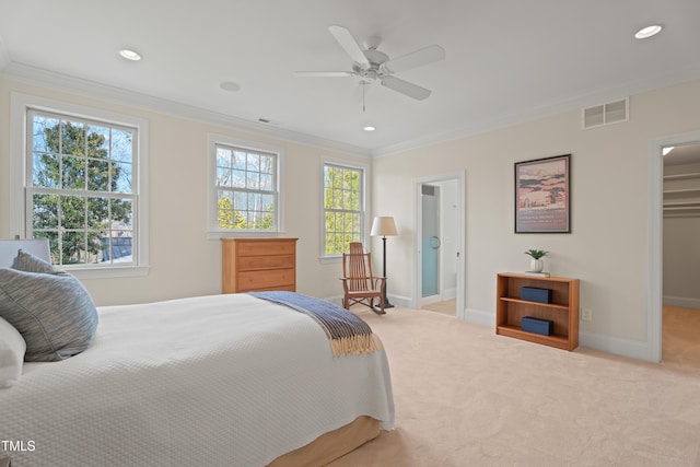 carpeted bedroom featuring multiple windows, visible vents, and crown molding