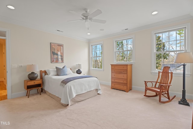 carpeted bedroom featuring baseboards, visible vents, and crown molding