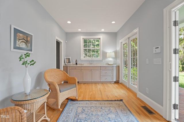 sitting room with light wood-style flooring, visible vents, baseboards, and recessed lighting