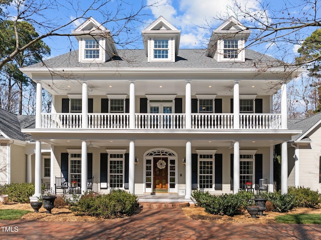 view of front of house with a balcony and covered porch