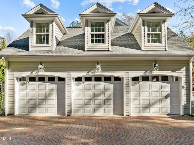 garage featuring decorative driveway