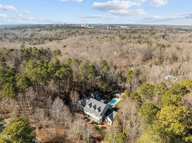 drone / aerial view featuring a wooded view