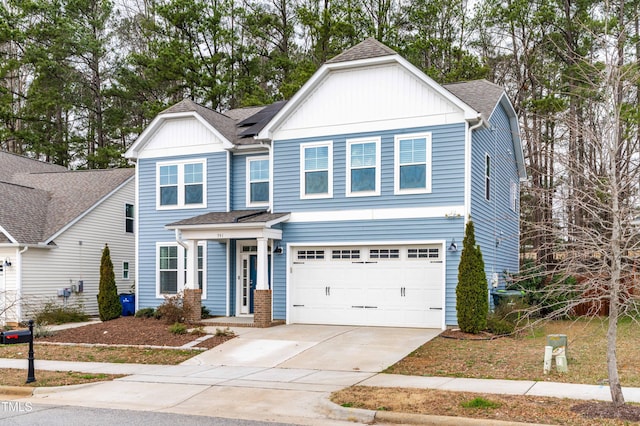 view of front of house with an attached garage, board and batten siding, driveway, and a shingled roof