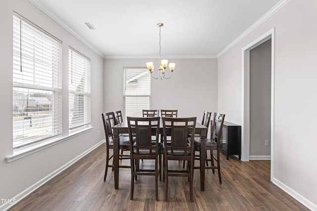 dining area with dark wood-type flooring, crown molding, baseboards, and a chandelier