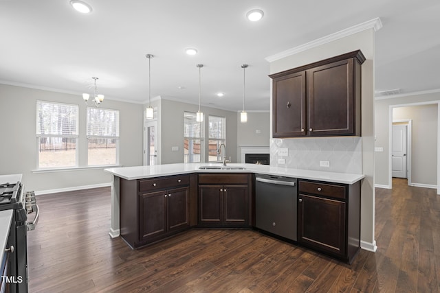 kitchen with a sink, dishwasher, a peninsula, and light countertops