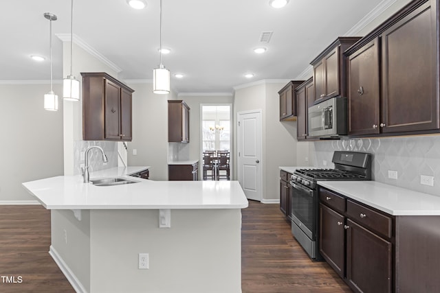 kitchen featuring a sink, a peninsula, dark brown cabinets, and stainless steel appliances